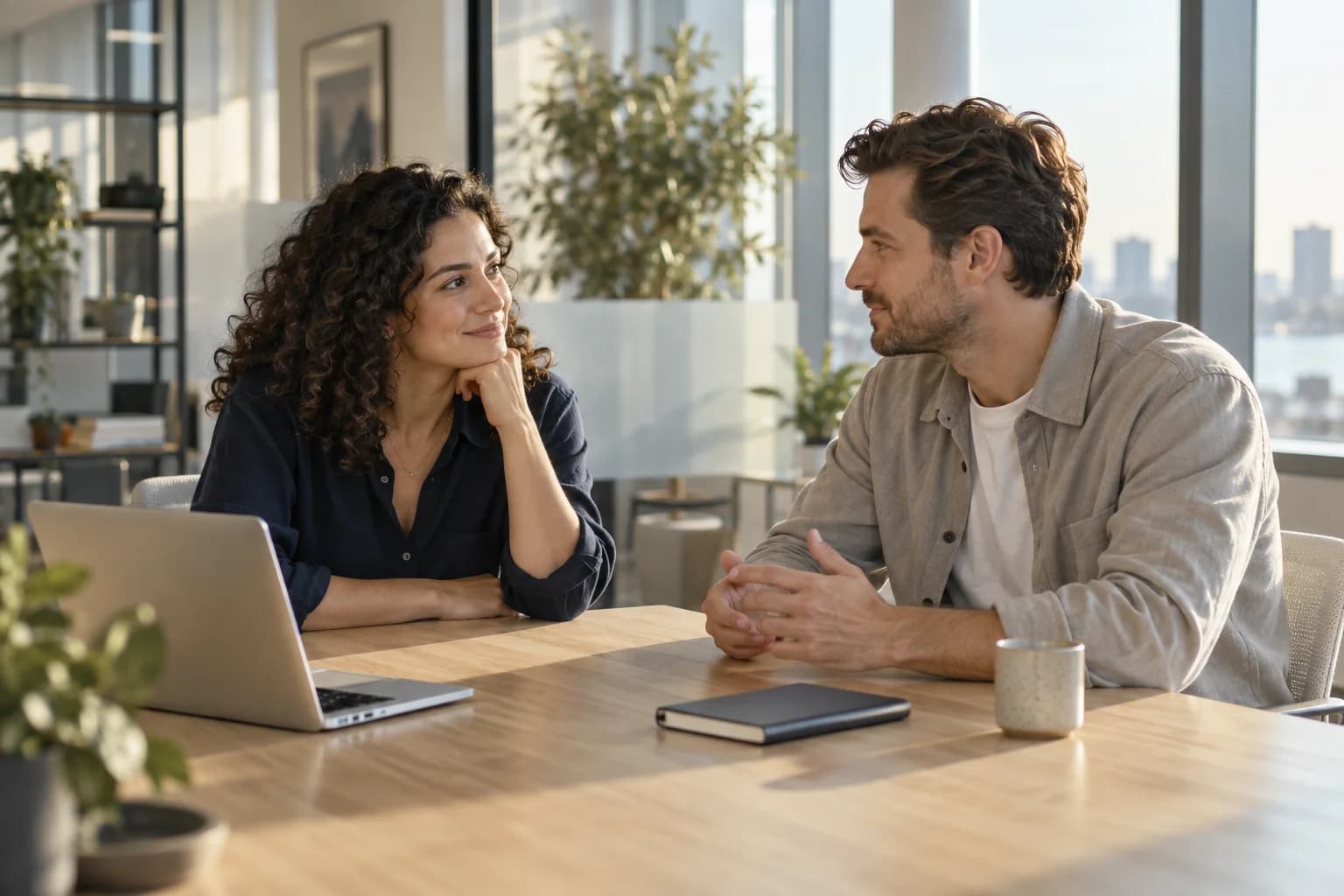 Two colleagues in conversation across a table