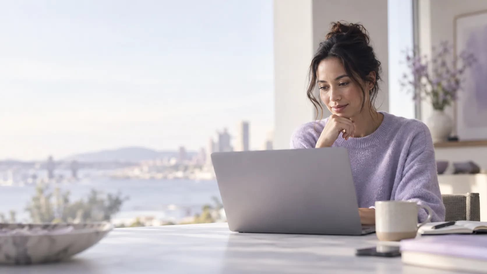 A seller reviewing her day on a laptop by the window